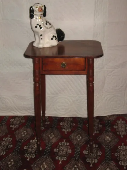 New England Worktable. In birch, delicate reeded, splayed legs, top with cookie cutter corners. Single hand dovetailed drawer with original brass pull. Old refinish.