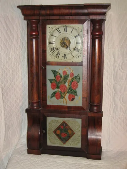 Circa 1830 Seth Thomas Clock. In the Empire taste, eight-day brass movement, triple deck with crotch rosewood veneer. Original painted dial and reverse paintings. Original label is mostly intact.