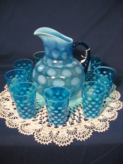 Blue Opalescent Coin Pitcher. Along with eight matching glasses.